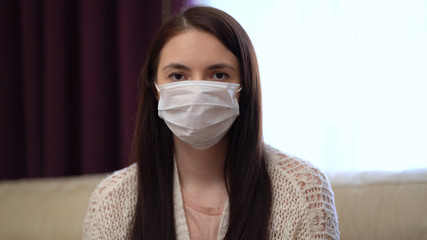 Pandemic, Portrait of a Young Woman Wearing Protective Mask at Home Due to Coronavirus Outbreak. Quarantine Covid-19 Corona Virus. Social Distancing Concept.