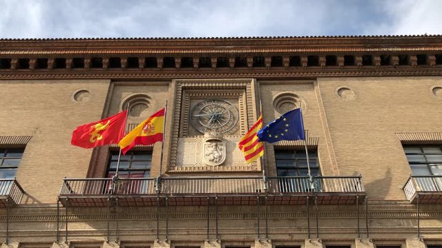 Zaragoza City Council in Plaza of Our Lady of the Pillar in Aragon, Spain, in a sunny day with blue sky, with fags of: Europe, Spain, Aragon, Zaragozza.