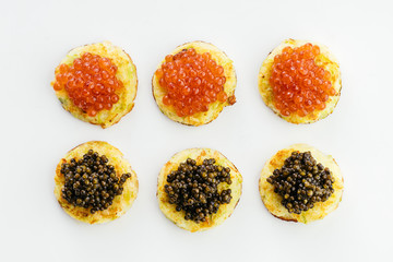 Red and black caviar on toasts. View from above.