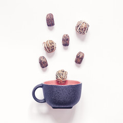 Puer tea and tea tied in balls together with a concrete mug are on a white background. Minimalistic tea ceremony concept. Flat lay.