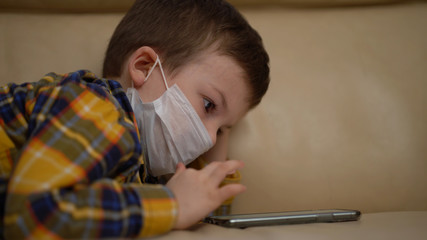 Boy Medical Mask on Face Due to Coronavirus Outbreak. Quarantine Covid-19 Corona Virus. Social Distancing Concept