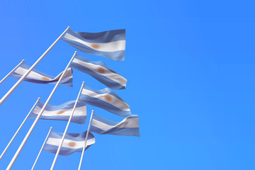 Argentina flags waving in the wind against a blue sky. 3D Rendering