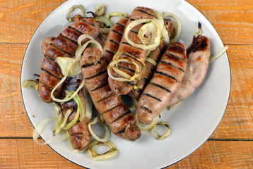 
delicious grilled sausages presented on a dish on a table