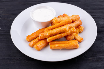 Cheese sticks, served with sour cream
