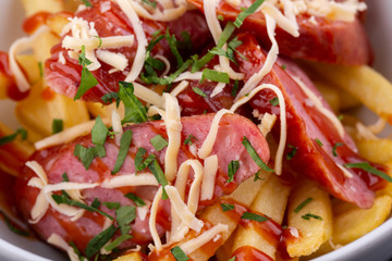Salad with sausage, grated cheese, potatoes and ketchup with greens