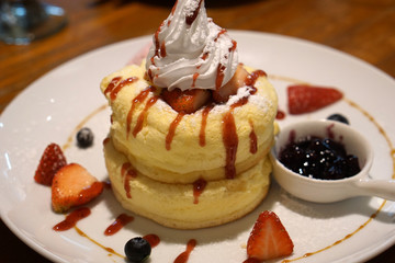 Japanese Souffle Pancake with strawberry, blueberry and cream