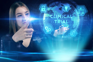 Business, Technology, Internet and network concept. Young businessman working on a virtual screen of the future and sees the inscription: Clinical trial