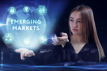 Business, Technology, Internet and network concept. Young businessman working on a virtual screen of the future and sees the inscription: Emerging markets