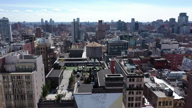 A high angle view of the buildings in Greenwich Village, NY. It's a sunny day, as the camera views the horizon, then tilt down to a geometric pattern, colorfully painted on the facade of a building.