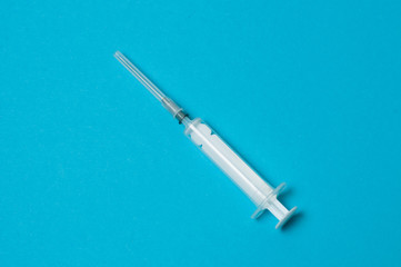 Medical syringe isolated on a blue background