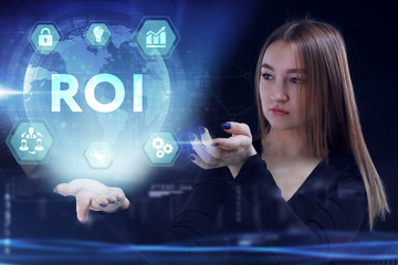 Business, Technology, Internet and network concept. Young businessman working on a virtual screen of the future and sees the inscription: ROI
