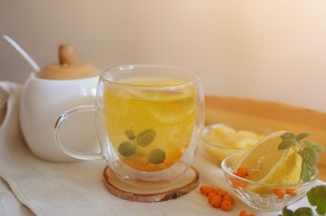 Healthy herbal drink against viruses of sea buckthorn with mint, lemon and honey