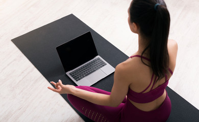 Young woman doing breathing exercises or meditation following online yoga tutorial, above view. Mockup for design