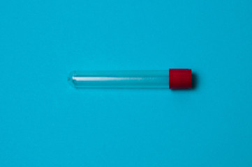 One blood collection tube on a blue background
