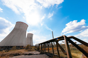 Smoking pipes, poles with wires of atomic thermal power plant at summer