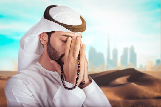 Arabic man doing Duaa in the middle of desert. Arab man asking god for mercy, Ramadan holy month for muslim people.
