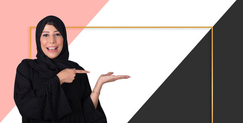 Young beautiful Arabic business woman over colored background Pointing to the side with hand and...