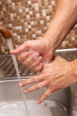 hand washing with soap on a warm brown background