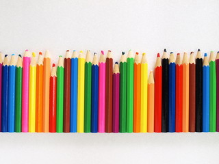 Colored used pencils on a white background. Selective Focus