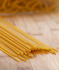 spaghetti pasta dried and lying on a wooden board