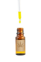 Cannabidiol oil in the bottle and dropper isolated on white