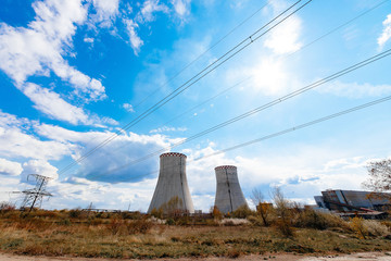 Obraz premium Cooling towers of a nuclear power plant in the back light