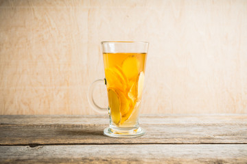 Healthy hot beverage with lemon, ginger and spices for protection in flu season. Selective focus. Shallow depth of field. 
