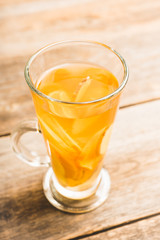 Healthy hot beverage with lemon, ginger and spices for protection in flu season. Selective focus. Shallow depth of field. 
