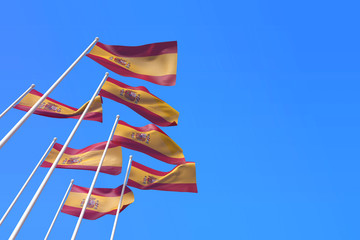 Spain flags waving in the wind against a blue sky. 3D Rendering