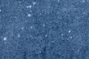 Background: blue cement wall with moss stains