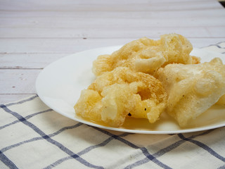 Dried fish maw on wooden table.