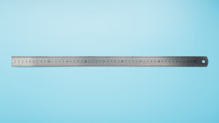 A metal ruler with a scale on a blue background is a superscape with a copy of the space for your text.
