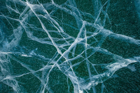 Texture of transparent ice with cracks on lake Baikal © savva_25