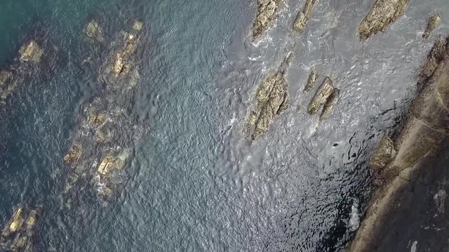 Aerial coastline water to reveal ruined castle 