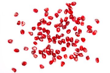 Red pomegranate grains on a white background