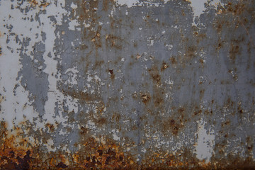 Rusty metal wall that's painted gray