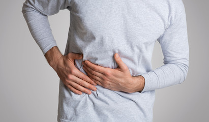 Cirrhosis of liver. Man holding hand in area liver