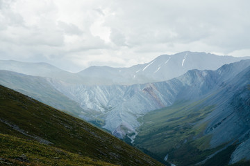 Fototapeta premium Unimaginably vast expanses of highlands. Immense distances with long valleys and giant mountain ranges. Awesome landscape of mountain vastness. Huge sharp ridge between two valleys. Great mountains.