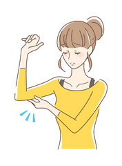 二の腕を触る女性