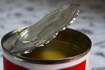 Can of sweetened condensed milk that has been opened