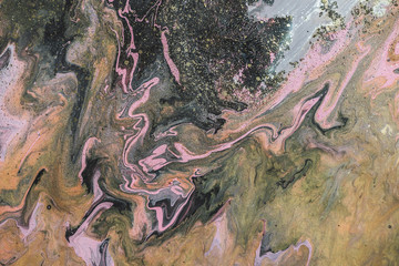 Fantasy fluid art background with dark green, orange and pink tints. Dirty marble effect of acrylic paints. Chaotic liquid ink of oxide tones. Toxic surrealistic abstract texture with mix swamp colors