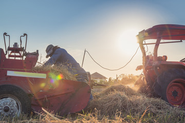 fixing header on old combine,Farmer in combine harvester harvesting crop from the field..