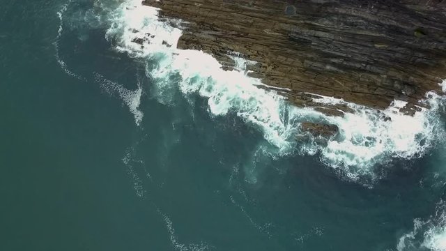 Aerial Irish coastline swell and foam