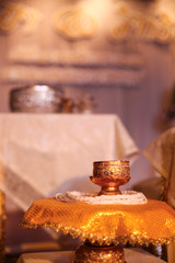 Small gold bowl Thai style thread around on tray with pedestal in marriage ceremony