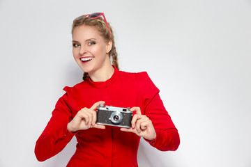 Youth Ideas and Concepts. Cute and Positive Caucasian Blond Girl With Old School Film Camera in Red...