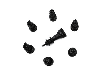 The black king placed in the middle of six different black pawns making a circle