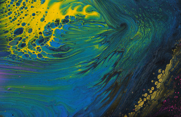 art photography of abstract marbleized effect background. Black, blue, green, gold and yellow creative colors. Beautiful paint