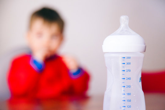 lunch time for an unrecognizable baby boy to drink his milk