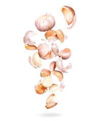Garlic cloves are falling down closeup, isolated on a white background