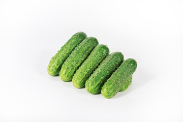 Group of fresh green pickling cucumbers on white background